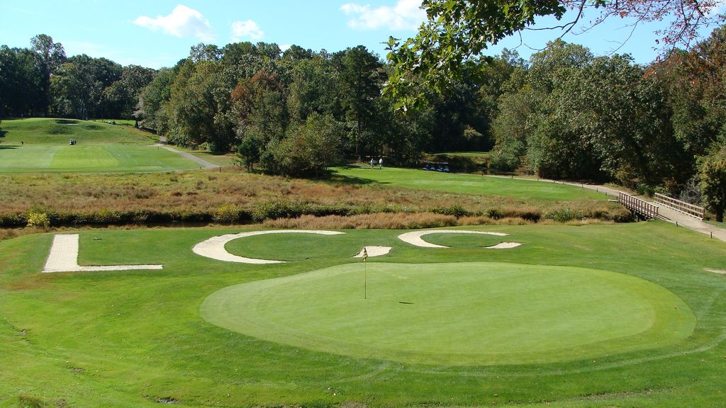 Golf course with LCC (Lakewood Country Club) initials on grass